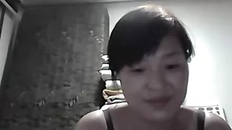 Wonderful mature Asian wife flashing her tits on camera